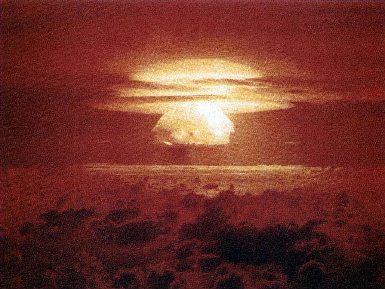 The Castle Bravo fireball and cloud over Bikini Atoll on 1 March 1954. Photo: United States Department of Energy, public domain, via Wikimedia Commons