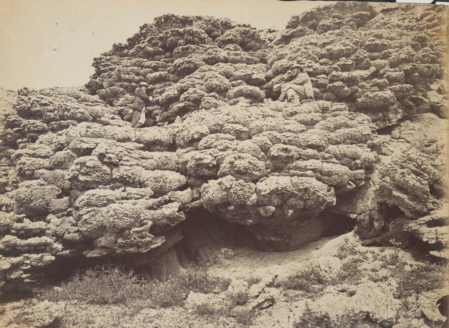 Albumen photograph by Timothy O'Sullivan, 1867: two men of Clarence King's Fortieth Parallel Survey sit and stand among knobbly tufa rock formations at Pyramid Lake, Nevada