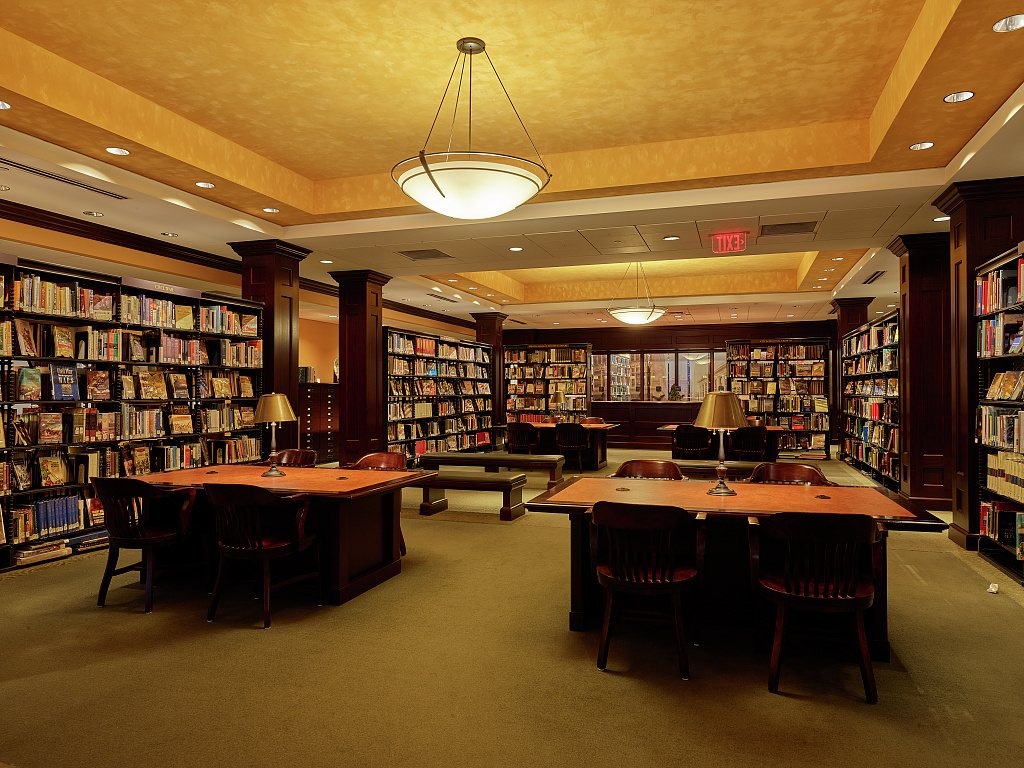 Reading room of the Kansas City Central Library in Missouri, with wooden tables, lamps and bookshelves, photographed in 2021