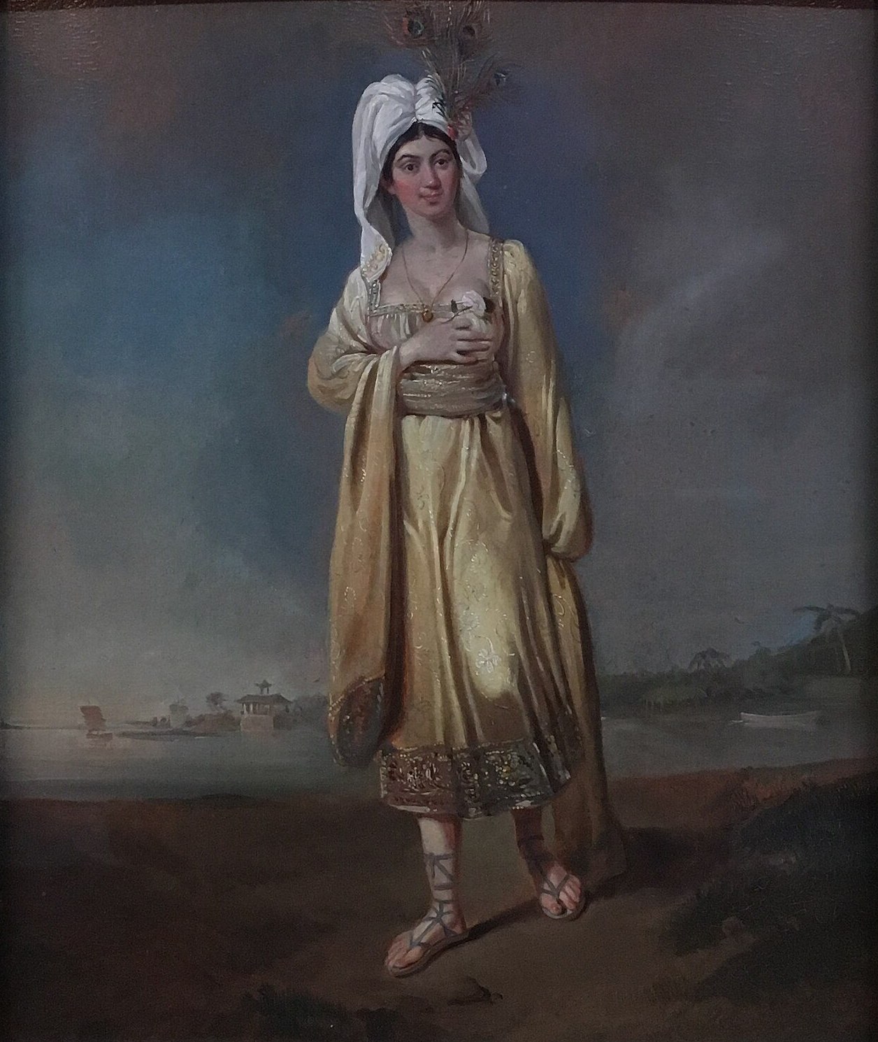 Oil painting of Princess Caraboo by Edward Bird, 1817: a young woman in a white turban with feathers and a yellow dress, standing on a shore