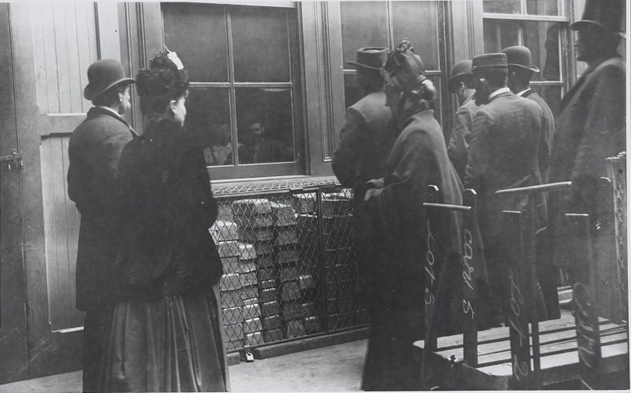 Photograph of visitors at a window of the Philadelphia Mint in 1888